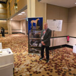 Peter standing next to his banner.