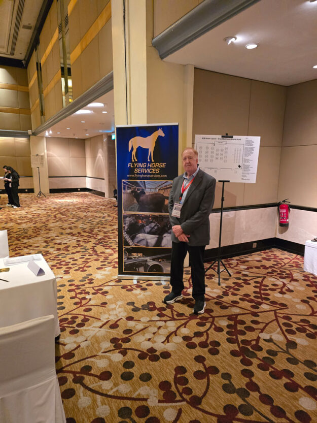 Peter standing next to his banner.